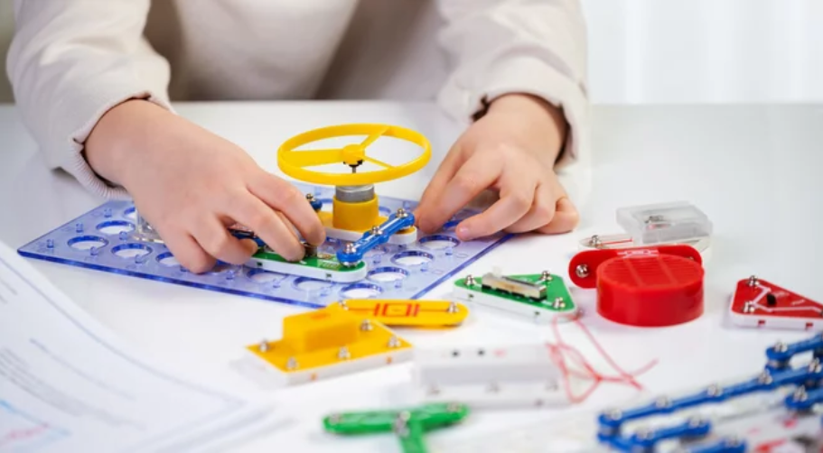 Child playing with STEM Toys Electronics and Circuitry Kits