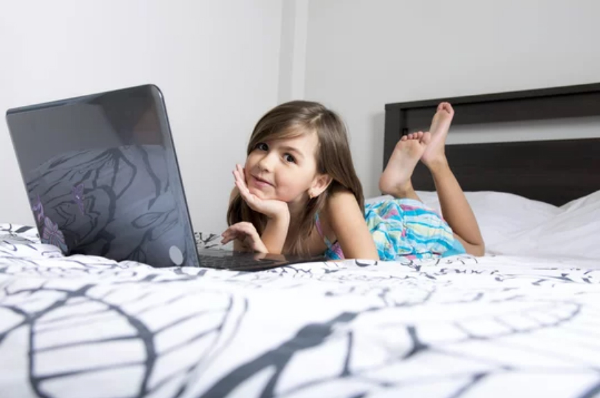 10 years old girl with laptop playing stem games