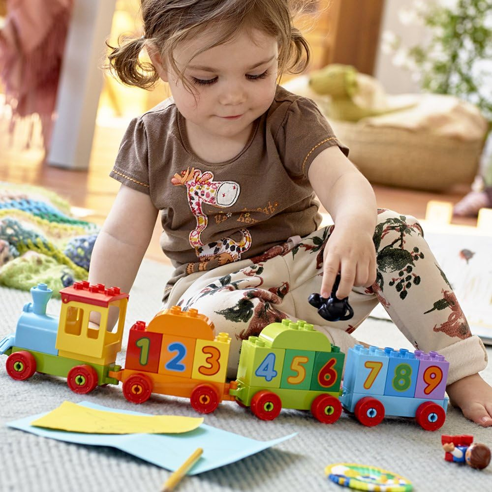 Three years old playing with LEGO DUPLO Train